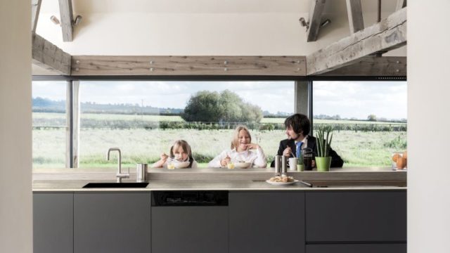 Caucasian father and children eating breakfast in kitchen